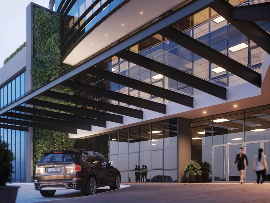 Edificio vertis en pase los proceres de color negro, con varios niveles de oficinas y estacionamiento enfrente.