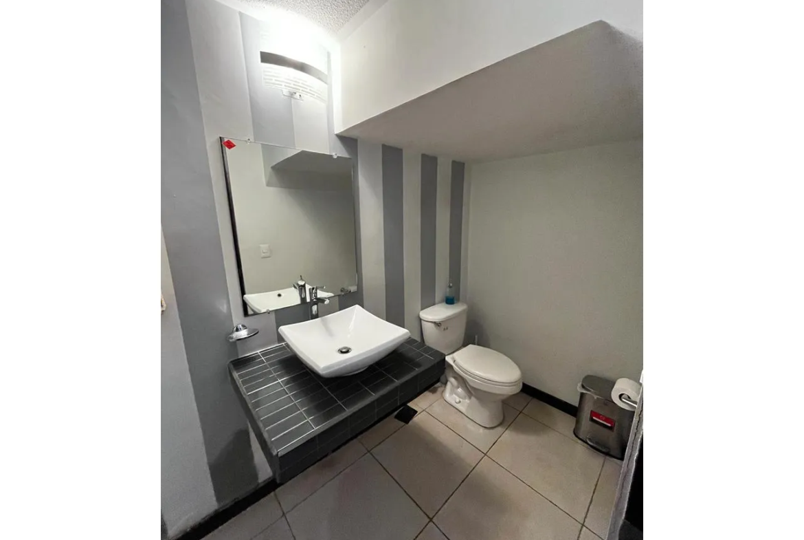 El baño de visitas ofrece un lavado suspendido que da un toque especial, espejo y tasa de baño. Además, cuenta con buena iluminación.
